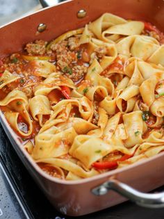 a pan filled with pasta and meat sauce