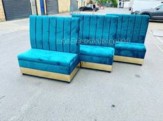 three blue couches sitting on the side of a road