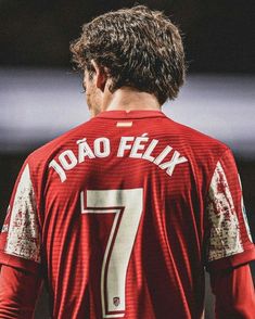 the back of a soccer player's red jersey with white writing and numbers on it