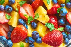 fresh fruit salad with pineapples, strawberries and blueberries