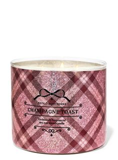 a pink candle that is inside of a glass container with the words champagne toast on it