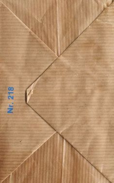 a piece of brown paper with blue numbers on it