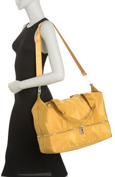 Stay stylish when traveling. The roomy interior of this Madden Girl weekend bag fits some of your favorite outfits and toiletries. - Dual top handles- Detachable, adjustable shoulder strap- Top zip closure- Exterior features slip pockets and bottom zip pocket- Interior features media pockets and zip wall pocket- Approx. 11" H x 19" W x 9.5" D- Approx. 12" handle drop, 19-30" strap drop - Imported Textile exterior and lining Trendy Satchel Weekender Bag With Zipper, Weekend Rectangular Shoulder Bag With Zipper Pocket, Trendy Satchel Weekender Bag With Zipper Closure, Rectangular Shoulder Bag With Zipper Pocket For Weekend, Weekend Rectangular Bag With Zipper Pocket, Rectangular Bags With Zipper Pocket For Weekend, Trendy Weekender Bag For On-the-go, Trendy Travel Satchel With Zipper Closure, Trendy Weekender Bag With Large Capacity For Travel