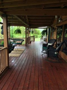 a wooden porch with chairs and tables on it