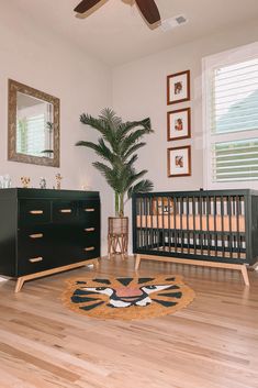 a baby crib and dresser in a room