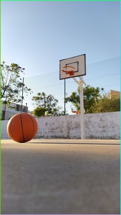 an orange basketball sitting on top of a basketball court