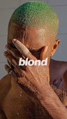 a man covered in mud with the word blond on his face