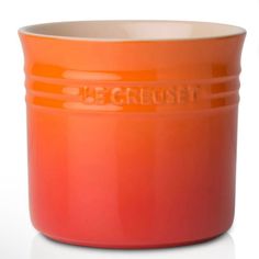 an orange bowl with the word uggrust on it's side is sitting in front of a white background