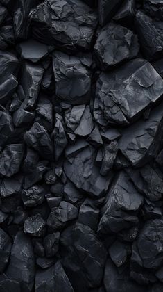 a pile of black rocks sitting next to each other