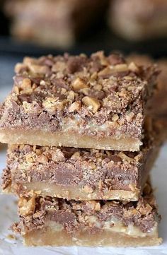 three pieces of chocolate and walnut bars stacked on top of each other, ready to be eaten