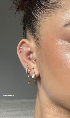 a close up of a person with ear piercings on their ears and behind the ear