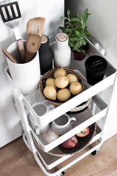 a kitchen shelf with pots and pans on it