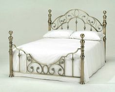 an image of a metal bed frame with white sheets and pillows on the front page