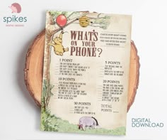 a winnie the pooh birthday party game is displayed on a wooden slice with an apple and