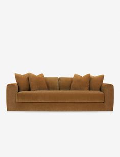 a brown couch with four pillows on it's back and one arm facing the camera