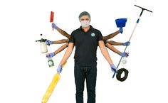 a man standing in front of a white background holding several different types of cleaning tools