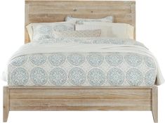 a bed with white and blue pillows on top of it's headboard in a bedroom