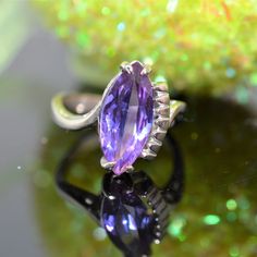 A ladies 10 karat white gold ring set with an approximate 7 millimeter by 15 millimeter marquise cut synthetic alexandrite.  This ring is size 5.5 14k White Gold Marquise Rings, Formal Purple Amethyst Ring Marquise Cut, Amethyst Marquise Ring With Prong Setting, Purple Marquise Cut Amethyst Ring For Formal Occasions, Classic Marquise Amethyst Ring, Marquise Amethyst Ring Fine Jewelry, Fine Jewelry Amethyst Marquise Ring, Fine Jewelry Marquise Amethyst Ring, Marquise Amethyst Anniversary Ring