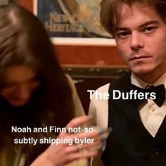 a man and woman sitting next to each other in front of a poster with the words, the duffers noah and finn not - so - subtily shipping yoler