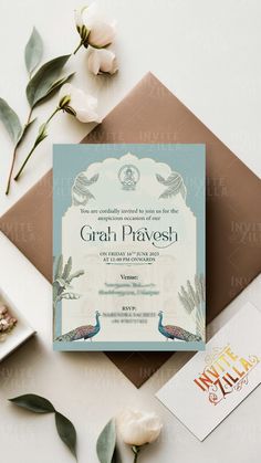 the wedding card is next to some flowers and an envelope with it's name on it