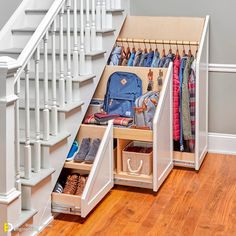 an under the stairs storage area with shoes and bags