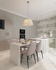 a dining room table with chairs and a television mounted on the wall above it, in front of a kitchen island