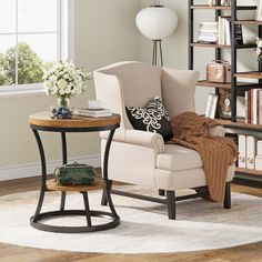 a living room with a chair, table and bookshelf