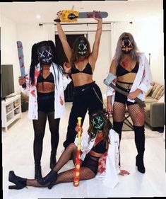 four women dressed up in costumes posing for the camera