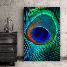 an image of a peacock's feather on a canvas in a room with a dresser