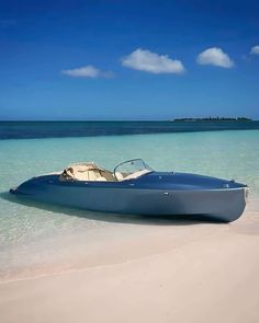 a small boat is parked on the beach