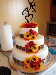 there is a wedding cake with flowers on it