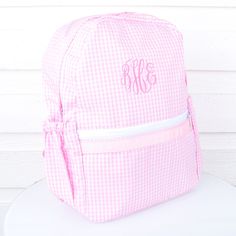 The cutest children's sized backpacks in a variety of sweet seersuckers, plaids and prints! Just perfect for that first day of school, camp and beyond! This item is not eligible for gift wrap. Small backpack measures 8.5" x 11"Medium backpack measures 11.5" x 15" The Medium size now comes with side pockets in all colors except Camo & Chambray! Maximum monogram width is 4 inch. Please note monogram sizing varies due to product size and monogram style. Gingham Backpack For Travel And School, Back To School Gingham Travel Backpack, Back To School Gingham Backpack, School Backpack In Gingham Pattern, Rectangular Pink Backpack For Daycare, Pink Seersucker, Medium Backpack, Pink Backpack, Pink Gingham