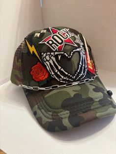 Rocker themed Trucker Patch Hat. These are the hottest trend on social media today. Great for festivals, concerts, night life and everyday wear. This foam trucker hat is fully adjustable and offered in hat colors Black, White, Light Pink, Neon Pink, Neon Yellow and Green Camouflage. Custom Hats avail. One size fits all. $45 Small Print: patch, mama, cowboy, hat, faith, rock and Roll, trucker, patch, cap, chain, iron on, sew on, festival, concert, neon, baseball cap, ball hat, chain, vintage, retro, trendy, patch hat, cowgirl, rocker mama, mom, beanie, rodeo, applique designs, embroidered, polyester hat, gifts for her, night life, everyday hat, collage cap, sparkly, sparkle hat, horse, charms Punk Style Adjustable Baseball Cap, Adjustable Punk Style Baseball Cap, Festival Trucker Hat Snapback, One Size, Festival Trucker Baseball Cap, Festival Snapback Trucker Hat, One Size Fits Most Snapback Trucker Hat For Festivals, Adjustable Punk Baseball Cap For Streetwear, Festival Trucker Snapback Baseball Cap, Festival Trucker Snapback Hat