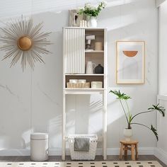 a white shelf with some plants and other items on it next to a potted plant