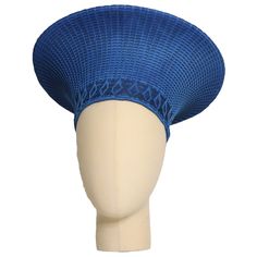 This elegant Zulu Basket Hat is the perfect accessory to upgrade any outfit. This piece is handmade by female artisans in South Africa. The hat is made out of woven grass, polyester cloth patterned with cotton, wool threads, and decorative glass beads. It can be worn on special occasions like birthdays, weddings, and formal gatherings. As with all handmade items, no two pieces are the same. Dimensions: 15" W x 7"H Head Size: 22" Woven Straw Hats With Structured Crown, Woven Straw Hat With Structured Crown, Adjustable Woven Blue Hats, Adjustable Blue Woven Hats, Blue Adjustable Woven Hats, Adjustable Woven Hat With Structured Crown, Blue Woven Wide Brim Sun Hat, Blue Wide Brim Woven Sun Hat, Adjustable Blue Toquilla Straw Hat