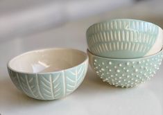 two bowls sitting next to each other on a table