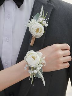 the bride and groom are wearing matching boutonnieres