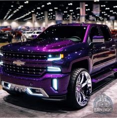 a purple truck is parked in a showroom