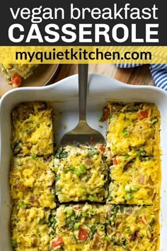 an egg casserole in a white baking dish with a serving spoon on the side