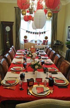 a dining room table set with plates and place settings