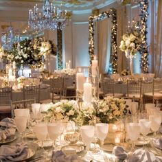 an image of a table setting with candles and flowers on the centerpieces for a wedding reception