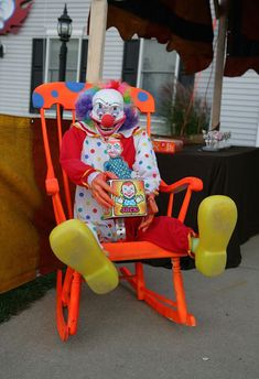 a clown sitting in a toy rocking chair