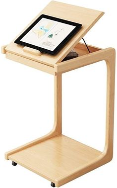 a small wooden table with a tablet on it's top and an electronic device in the middle