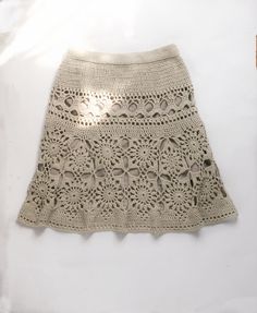 a crocheted skirt is displayed on a white surface