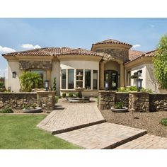 a large house with stone steps leading to the front door and landscaping area on either side