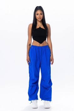 Royal blue cargo pants with an elastic waistband and adjustable ankles. Return Policy WE ONLY OFFER STORE CREDIT FOR RETURNS! Feel free to email us at info@shopluxxeapparel.com or DM us with any questions regarding fit, styling, or our return policy in general. To read more into our return policy please click here. Blue Stretch Pants With Cargo Pockets, Stretch Blue Pants With Cargo Pockets, Blue Straight Leg Parachute Pants In Cargo Style, Blue Straight Leg Cargo Parachute Pants, Blue Stretch Wide Leg Cargo Pants, Blue Cargo Style Straight Leg Parachute Pants, Blue Cargo Style Parachute Pants With Straight Leg, Blue Cargo Parachute Pants For Streetwear, Blue Cargo Pocket Parachute Pants For Streetwear