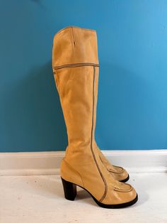 1970s creamy tan tall leather boots sz 7/7.5 Unbranded Gorgeous buttery soft tan leather Exposed black seaming detail throughout - very sleek! Wooden stacked heel  Slight platform Leather sole Marked size 9.5 but that is not US sizing Excellent condition. a few scuffs but do not detract  Heel 3 Sole to top of boot 19 CAlf at widest point 6.5 width (measured on sole) 3.25 Length (measured inside) 9.75 Retro Knee-high Platform Boots For Fall, Retro Knee-high Leather Boots, Retro Leather Knee-high Boots With Round Toe, Retro Leather Heeled Boots With Wide Calf, Retro Wide Calf Leather Heeled Boots, Vintage Leather Knee-high Boots With Round Toe, Retro Wide Calf Leather Boots, Vintage Knee-high Platform Boots, Fitted Vintage Cream Boots