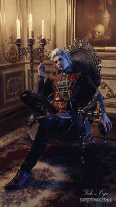 a man with blue hair sitting in a chair