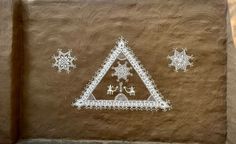 an artistic painting on the side of a building with snowflakes and stars around it