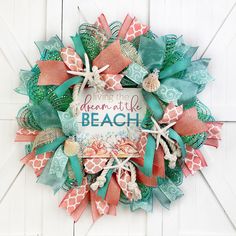 a wreath that says dreaming the beach with sea shells and starfishs on it